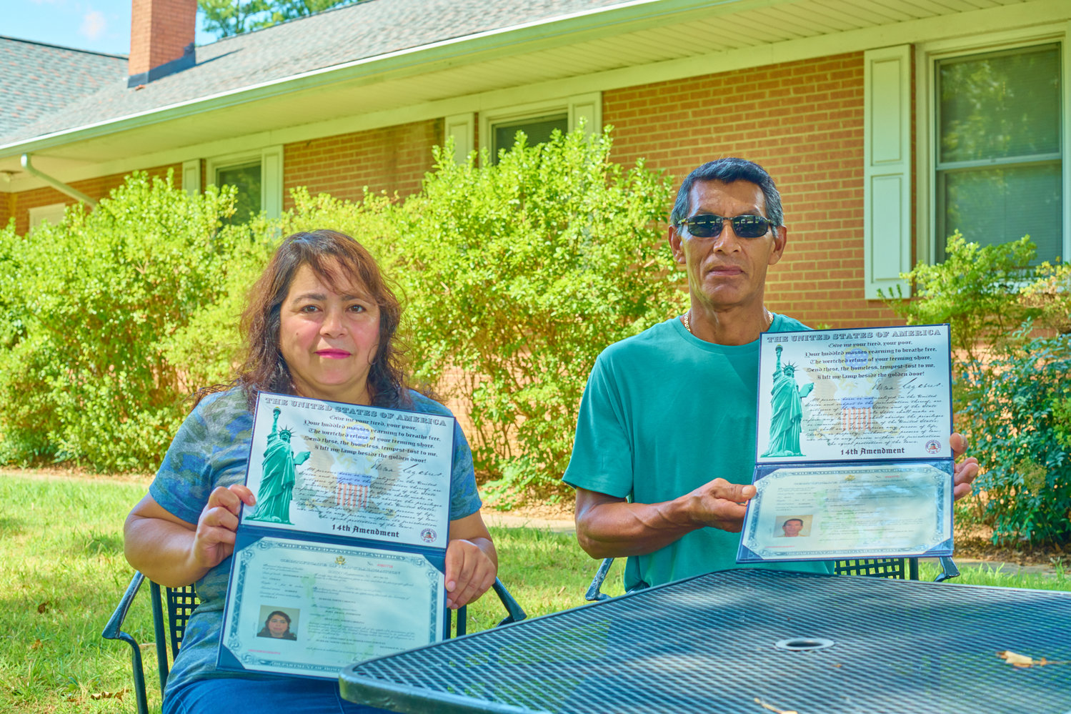 Dora Interiano and her husband José hold up their U.S. citizenship certificates, which both received last December with the help of Chatham Literacy.